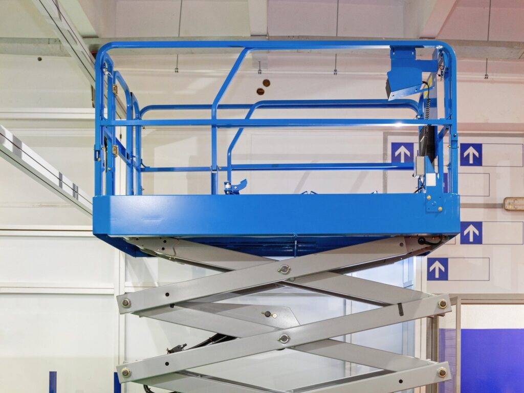 blue scissor lift in the hall