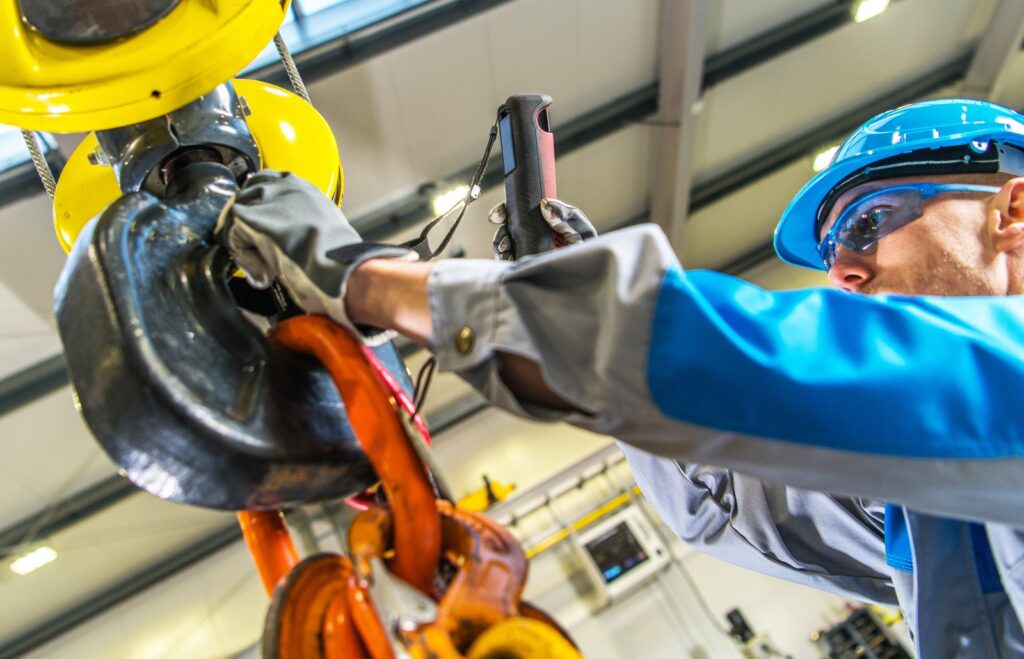 maintenance man repairs hoist