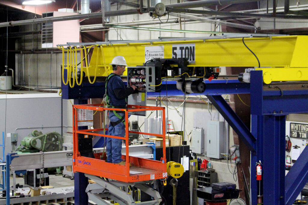 maintenance man repairs crane